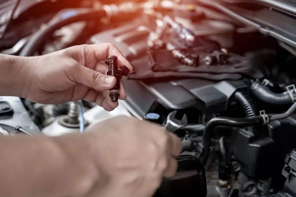 Technician,Use,Wrench,Removing,The,Gasoline,Injector,Part,On,Engine
